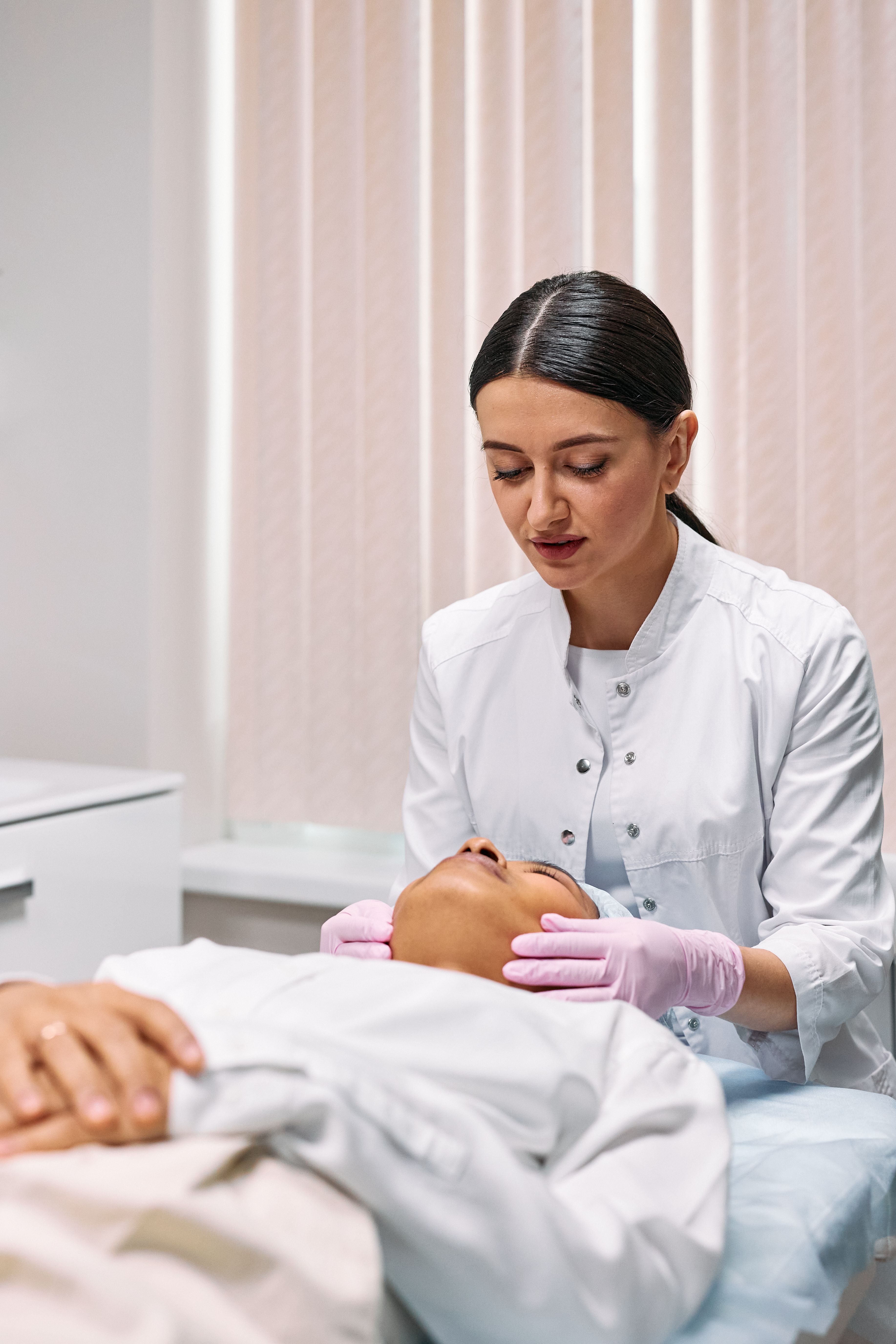 A beauty professional caring for a client during a treatment
